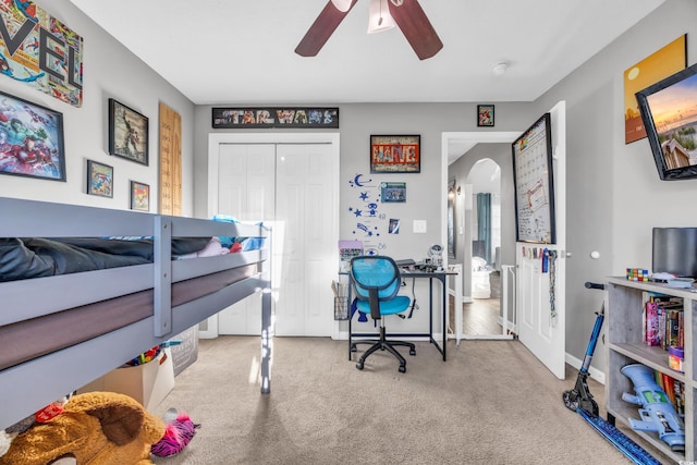 bedroom featuring a closet, light carpet, and ceiling fan