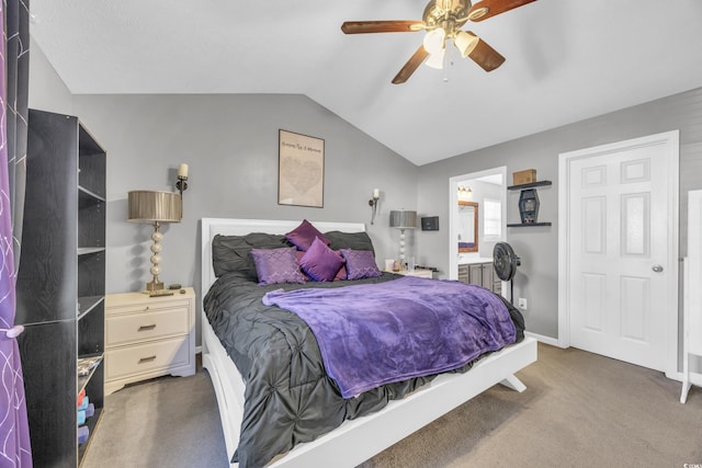 carpeted bedroom featuring lofted ceiling, ensuite bath, and ceiling fan