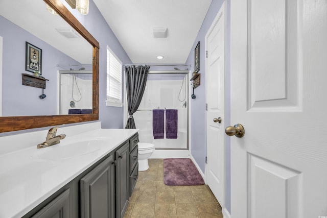 bathroom featuring toilet, tile patterned flooring, walk in shower, and vanity