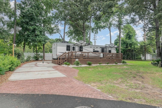 view of front of house featuring a deck and a front lawn