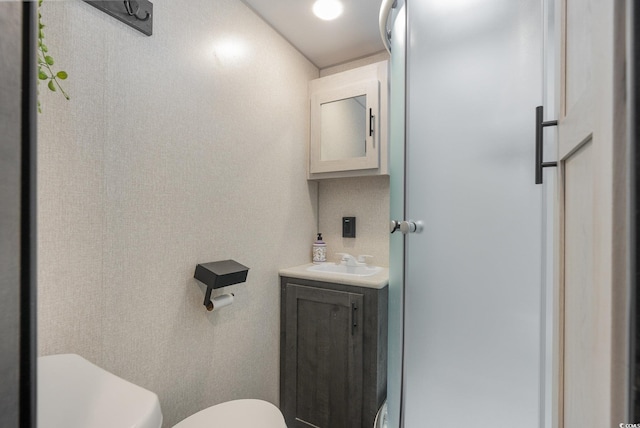 bathroom featuring vanity and toilet