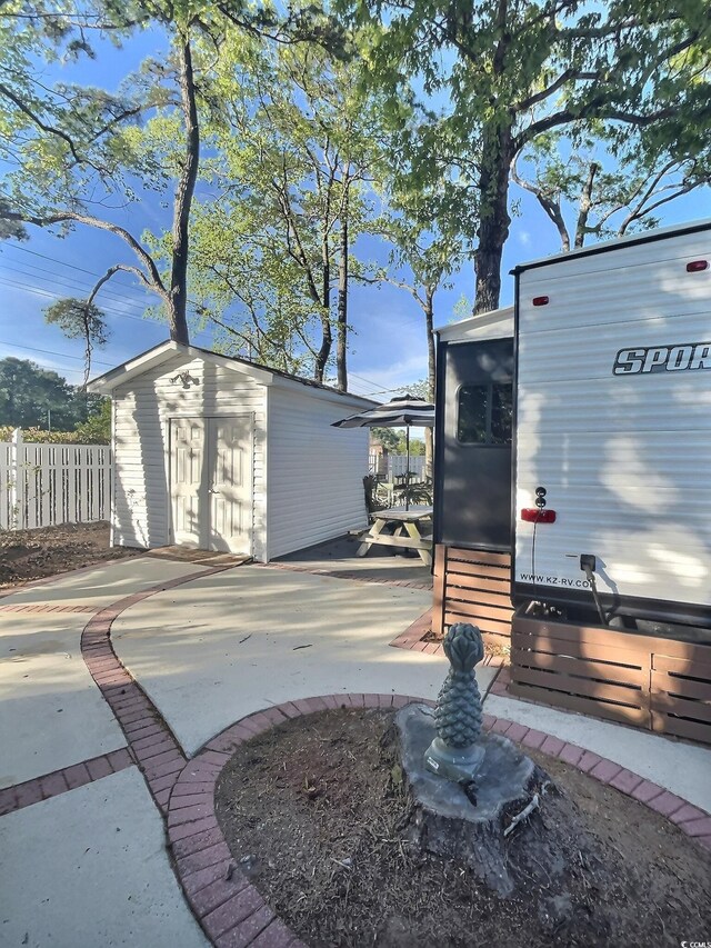 exterior space with a patio and a shed