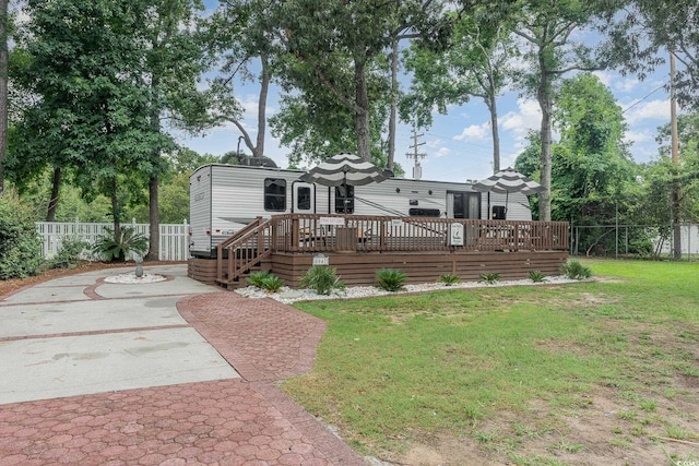 back of house with a lawn, a deck, and a patio