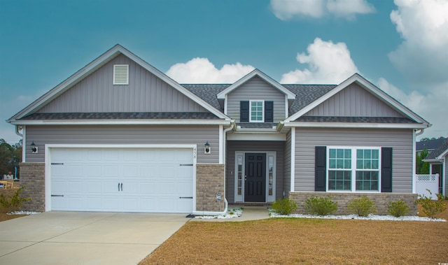 craftsman-style house with a garage, brick siding, driveway, roof with shingles, and a front lawn