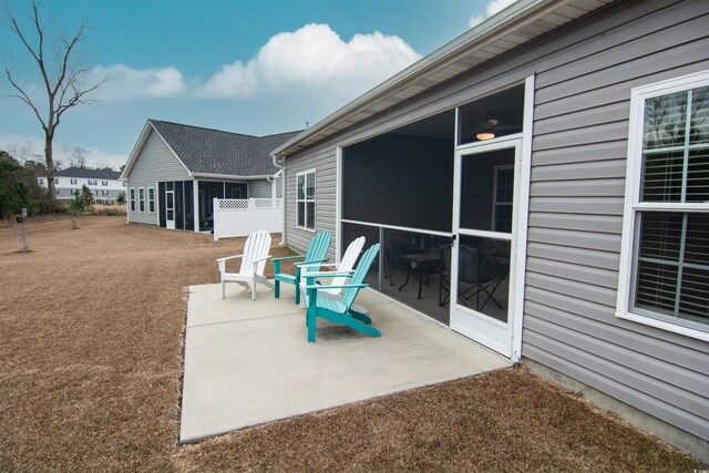 view of patio / terrace featuring a sunroom