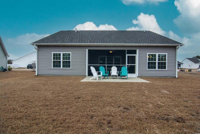 rear view of house featuring a patio and a yard