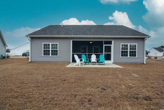 rear view of property featuring a patio area and a lawn