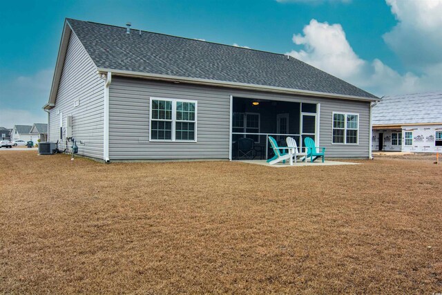 rear view of house with a yard, central air condition unit, and a patio area