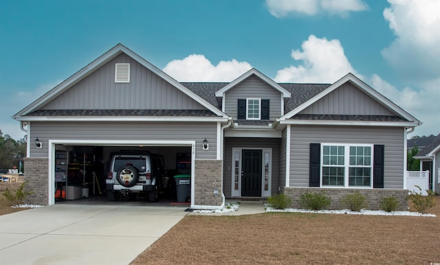 craftsman-style home featuring a garage and a front lawn