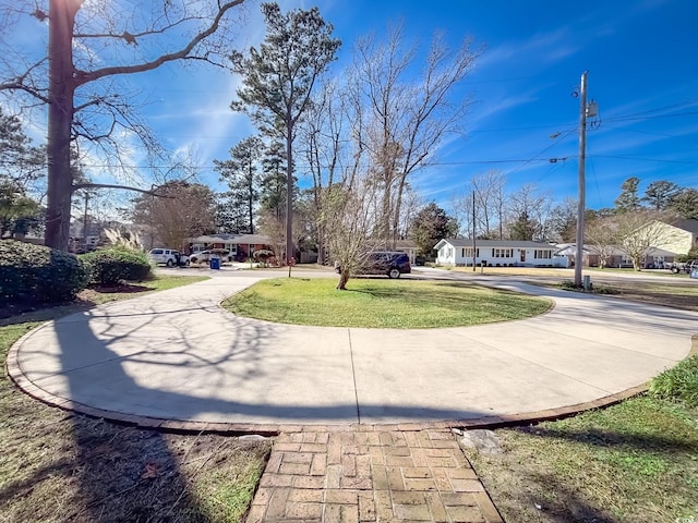 view of road with concrete driveway