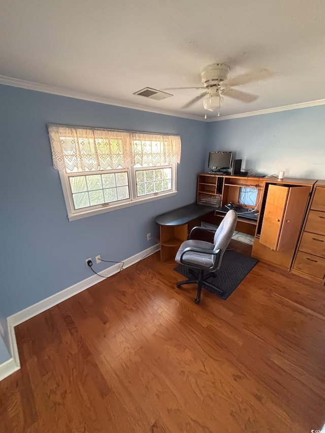 home office featuring ceiling fan, baseboards, wood finished floors, visible vents, and ornamental molding