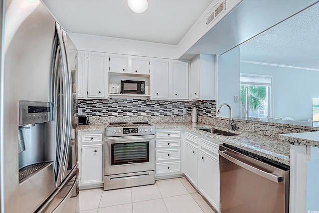 kitchen with visible vents, appliances with stainless steel finishes, decorative backsplash, and a sink