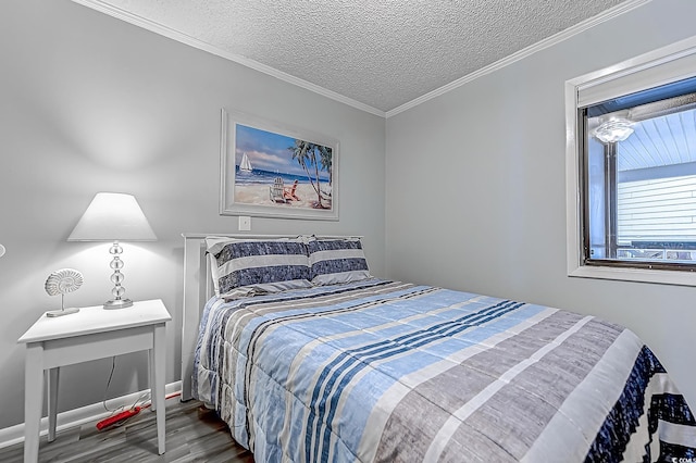 bedroom featuring a textured ceiling, ornamental molding, and wood finished floors