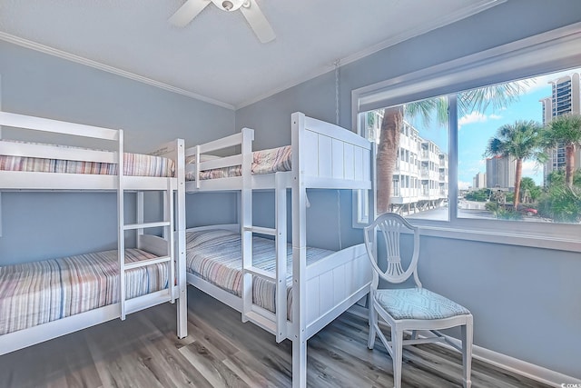 bedroom with crown molding, ceiling fan, and wood finished floors