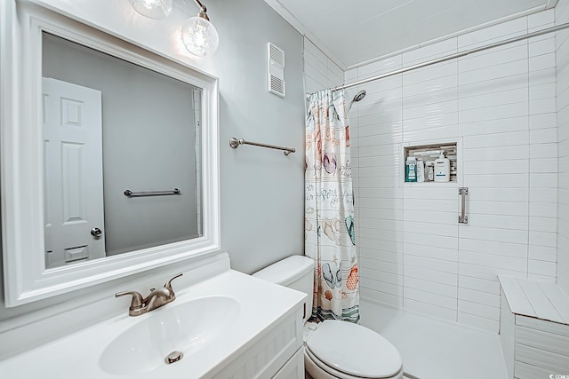 bathroom featuring toilet, visible vents, a tile shower, and vanity