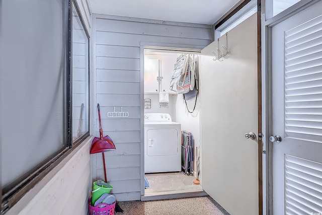 laundry area with laundry area, washer / clothes dryer, and wooden walls