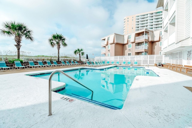 pool featuring a patio area and fence