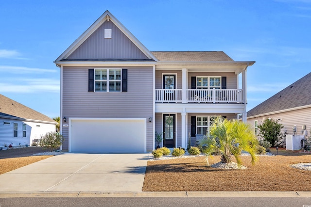 view of front of property with driveway, board and batten siding, an attached garage, and a balcony