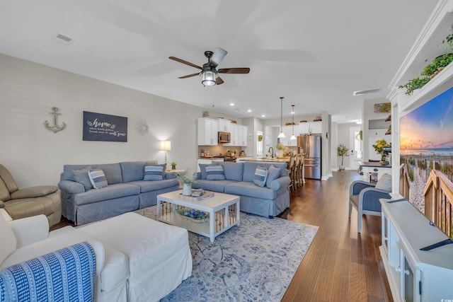 living area featuring recessed lighting, wood finished floors, visible vents, and a ceiling fan