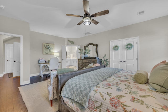 bedroom with baseboards, visible vents, a ceiling fan, dark wood-style floors, and a closet