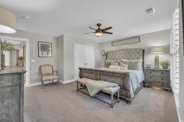 carpeted bedroom featuring ceiling fan, a closet, visible vents, and baseboards