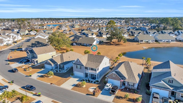 bird's eye view with a residential view and a water view