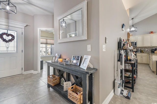 tiled entrance foyer with lofted ceiling