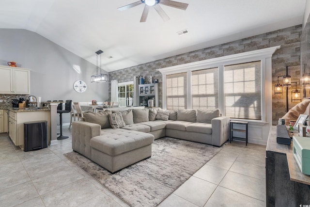 tiled living room with high vaulted ceiling, sink, and ceiling fan