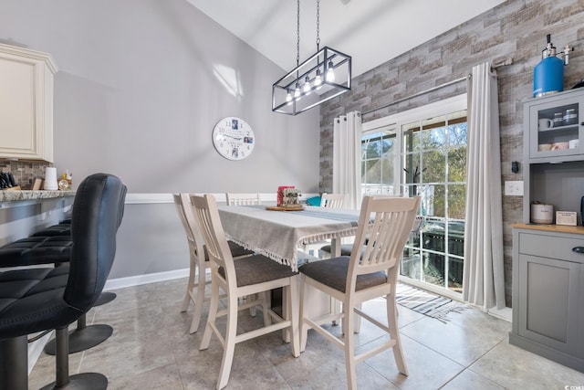 tiled dining area featuring high vaulted ceiling