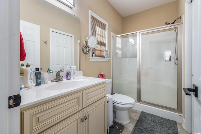 bathroom with tile patterned floors, vanity, toilet, and an enclosed shower