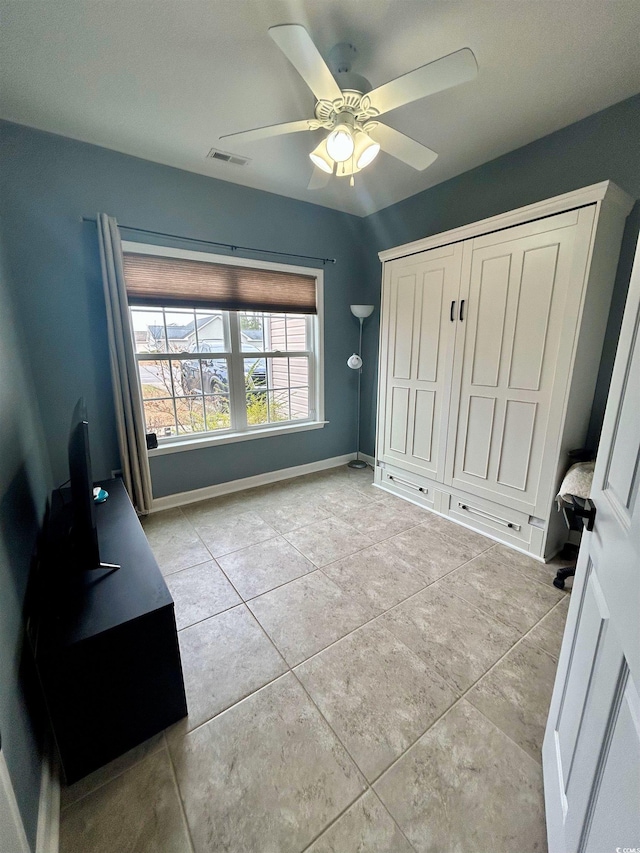 tiled bedroom with ceiling fan