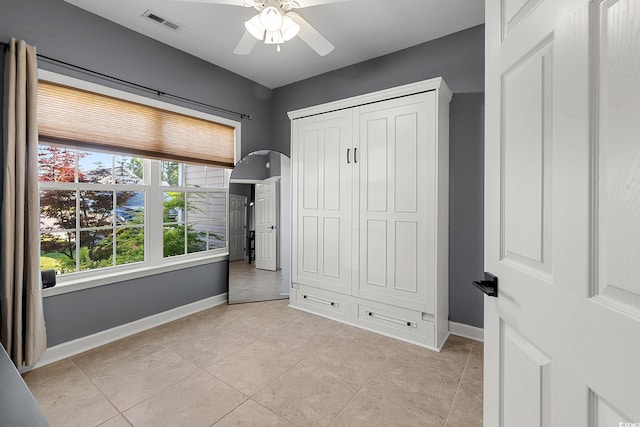 160 Maggie Way, Myrtle Beach, SC 29588 - unfurnished bedroom with light tile patterned floors, a closet, ceiling fan, and arched walkways