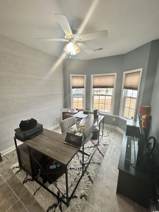 dining space featuring light tile patterned floors and ceiling fan