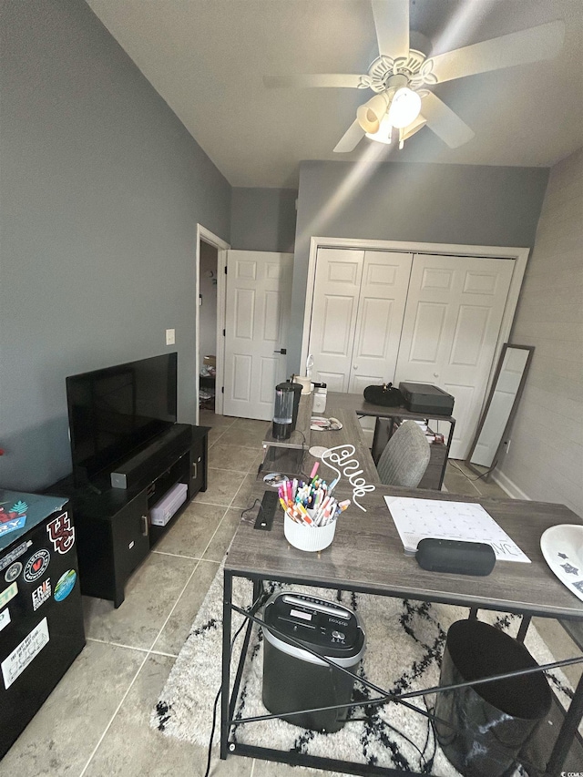 tiled living room featuring ceiling fan