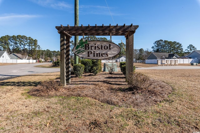 community / neighborhood sign with a lawn