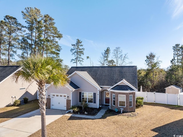 ranch-style house featuring a garage, central AC unit, and a front yard