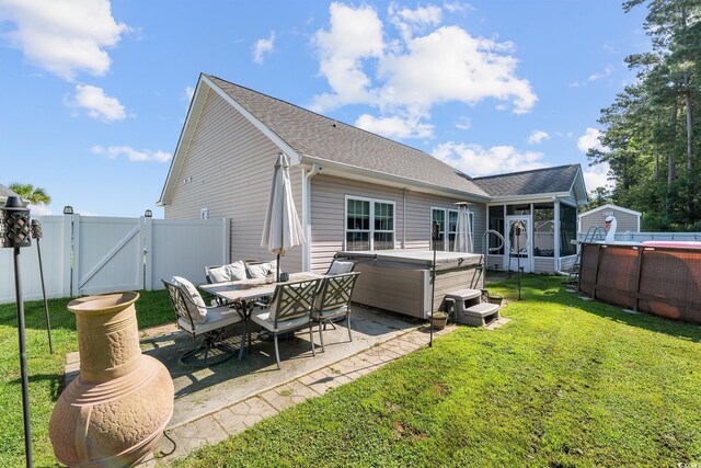 160 Maggie Way, Myrtle Beach, SC 29588 - back of house featuring a hot tub, a gate, a sunroom, a patio, and roof with shingles