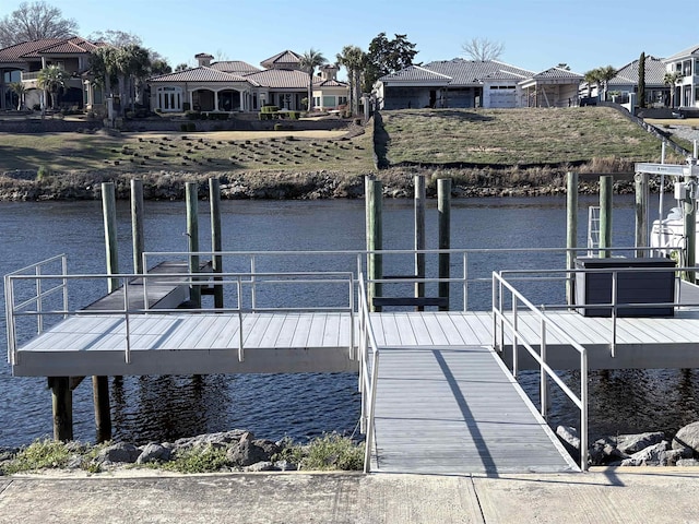 dock area featuring a residential view and a water view