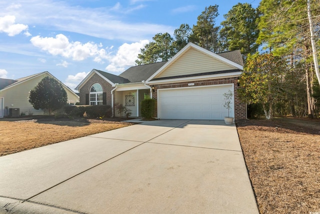 view of front of house with a garage and central air condition unit