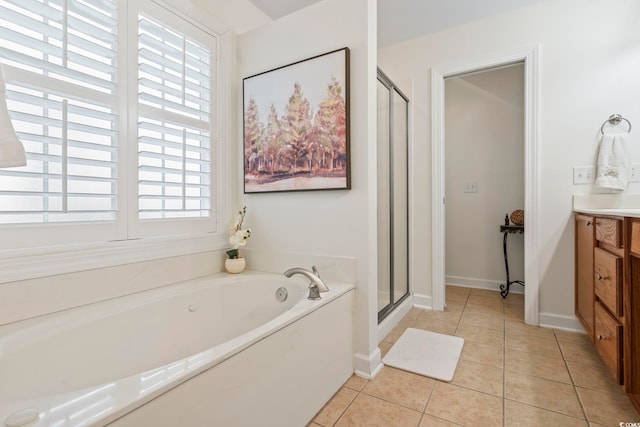 bathroom with tile patterned flooring, shower with separate bathtub, and vanity