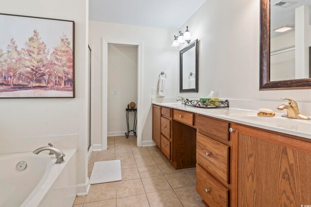 bathroom with vanity, tile patterned floors, and a bathing tub