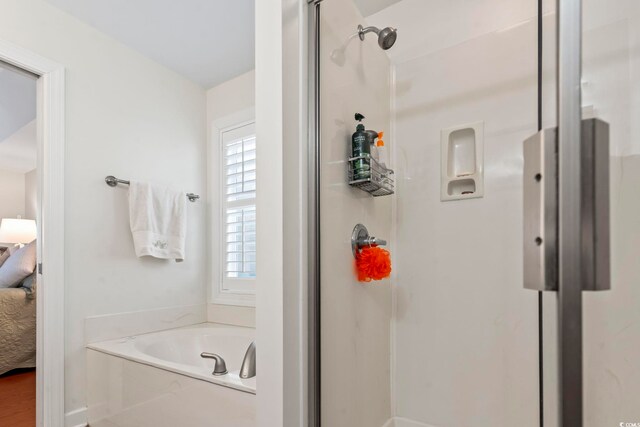 bathroom with separate shower and tub