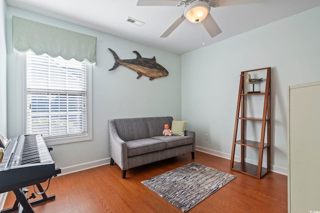 sitting room with ceiling fan, hardwood / wood-style floors, and plenty of natural light