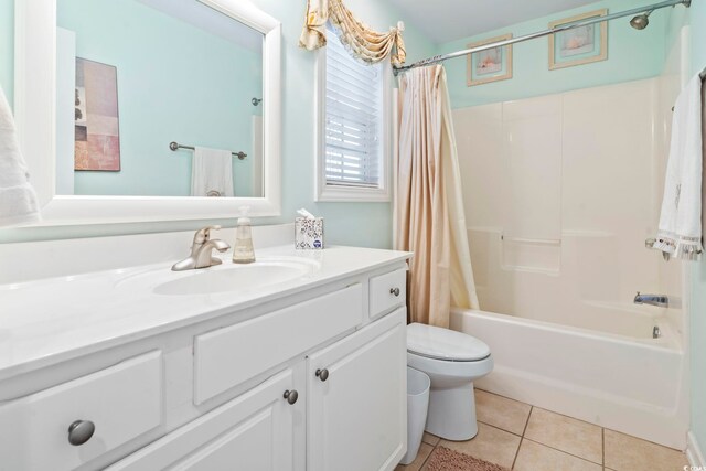 full bathroom with toilet, tile patterned floors, vanity, and shower / tub combo with curtain