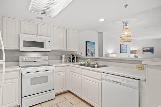 kitchen featuring sink, white appliances, light tile patterned floors, and white cabinets