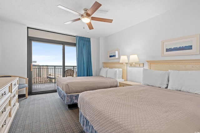 bedroom featuring access to outside, a textured ceiling, and ceiling fan