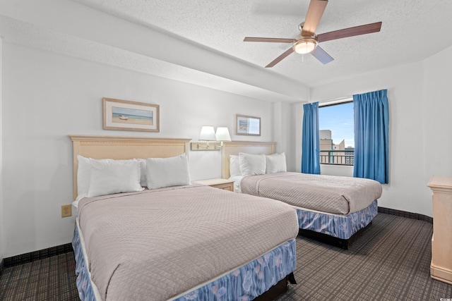 carpeted bedroom with ceiling fan and a textured ceiling