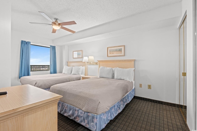 bedroom with a textured ceiling and ceiling fan