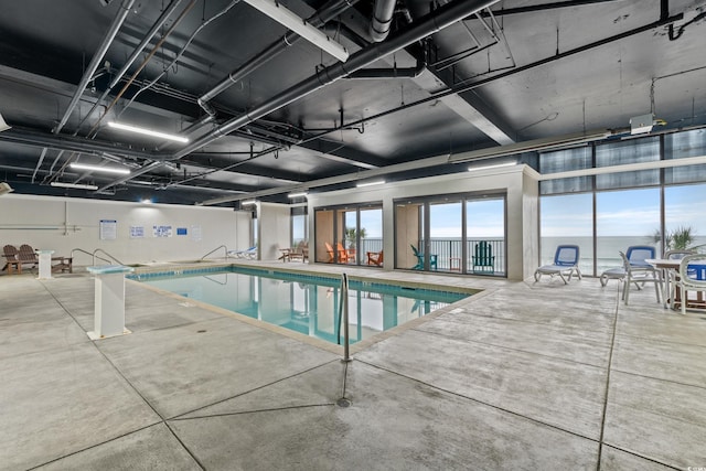 view of swimming pool featuring a water view