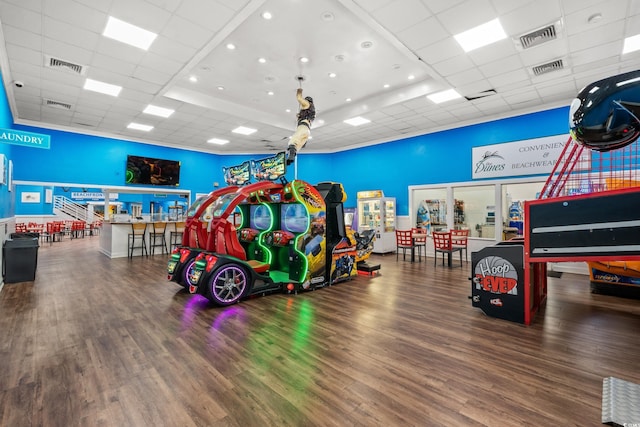 playroom with hardwood / wood-style floors and a drop ceiling